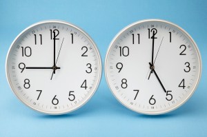 Office Clocks Showing Different Times --- Image by © Royalty-Free/Corbis